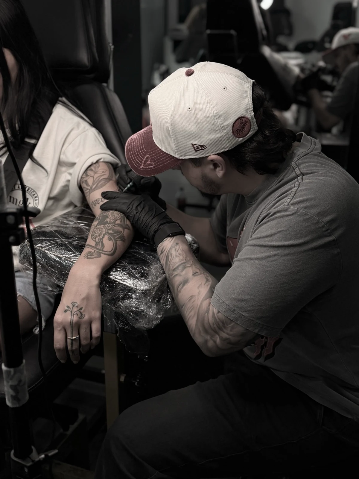 Monkeyno tattooing a client in the studio