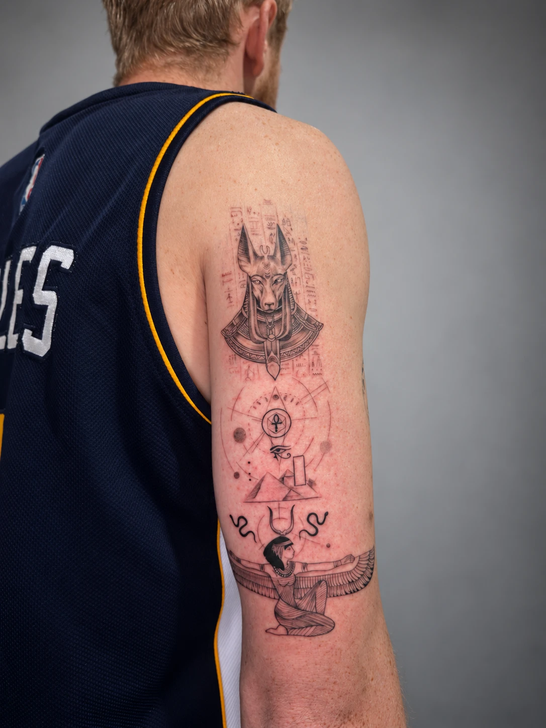 Egyptian piece with Anubis, hieroglyphs, pyramids and winged Isis on the back of the arm