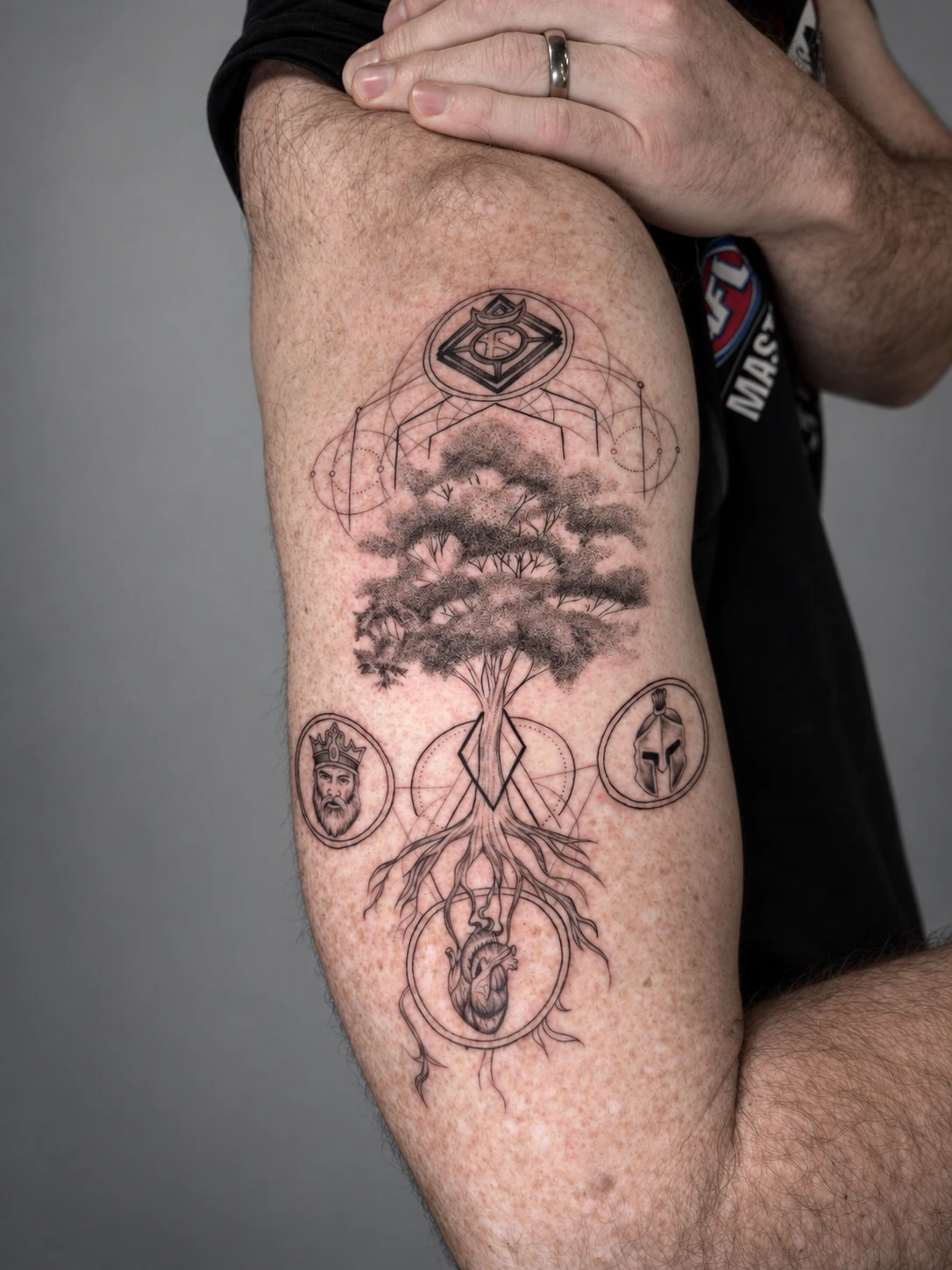Tree of life with an anatomical heart, a king and a Spartan helmet within geometric linework